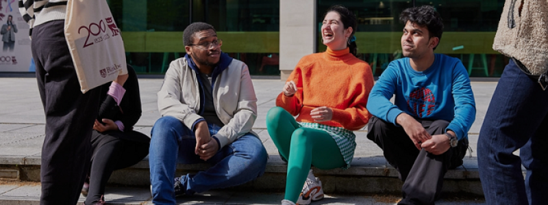 Students laughing and talking outside Birkbeck, University of London