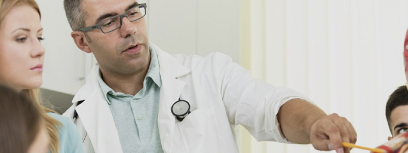 Medicine students and teacher with anatomy model